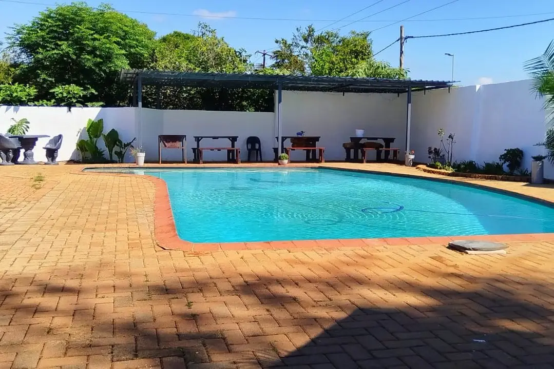 The outdoor swimming pool with a paved surround
