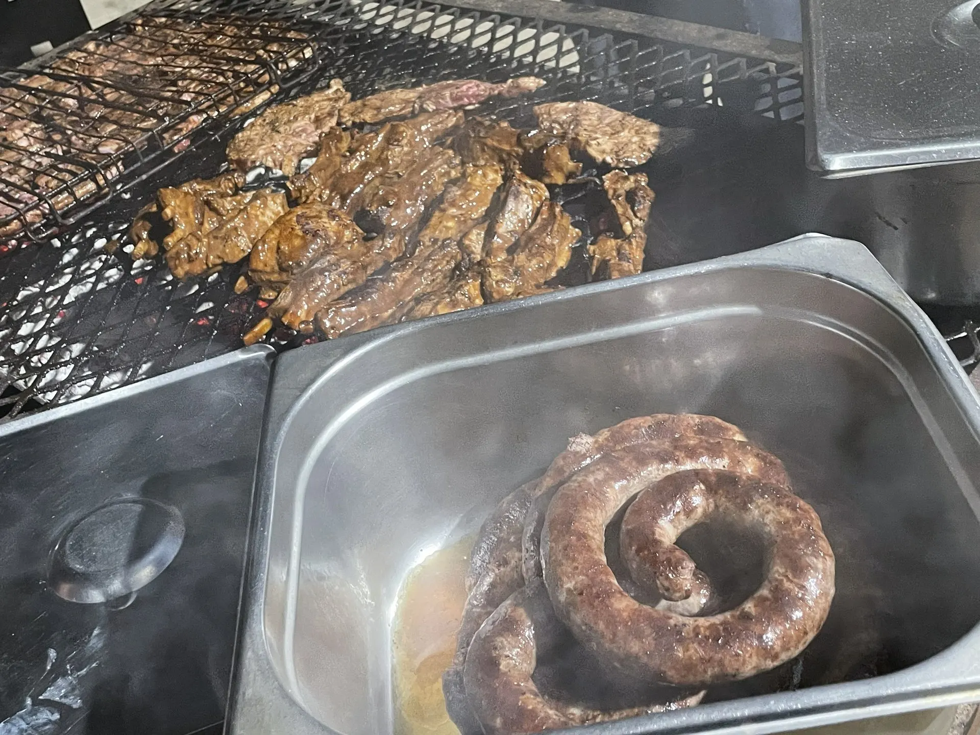 Boerewors and grilled meat cooking over the coals