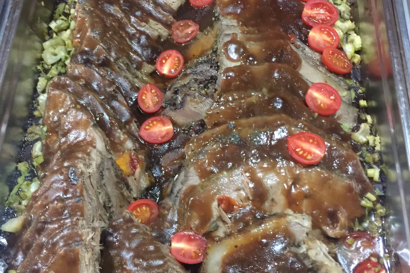 A buffet spread of grilled ribs and vegetables prepared in the kitchen