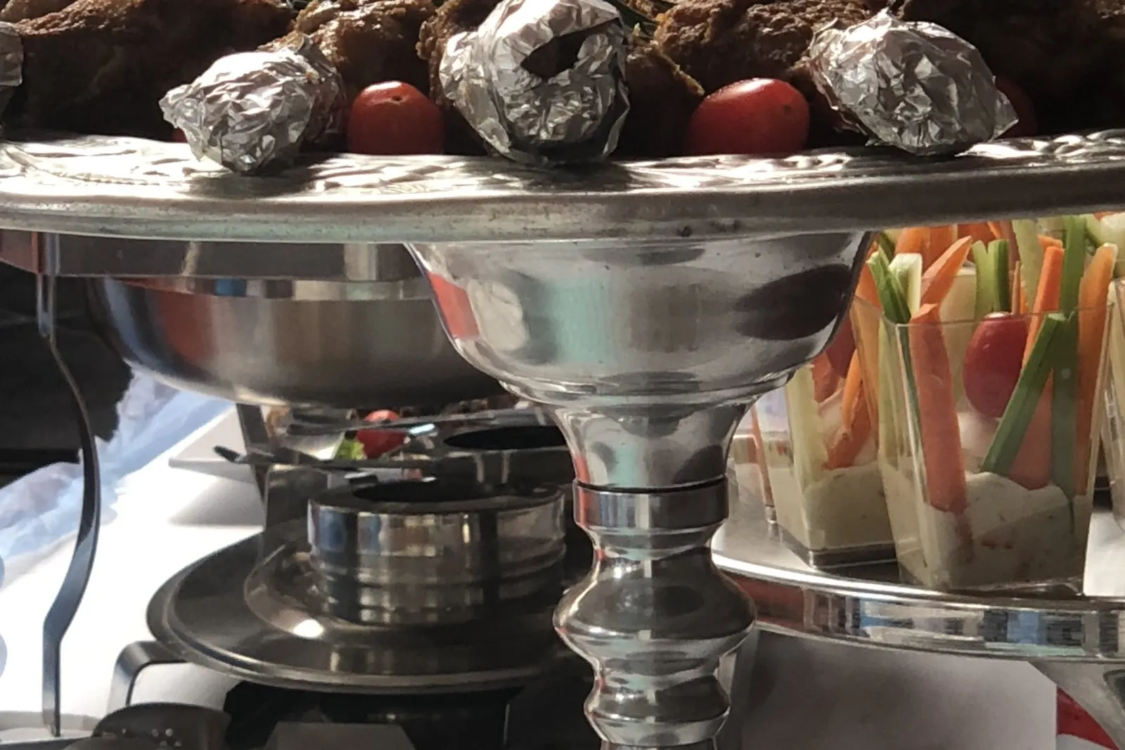 Canapés arranged on a tiered silver stand for a cocktail function