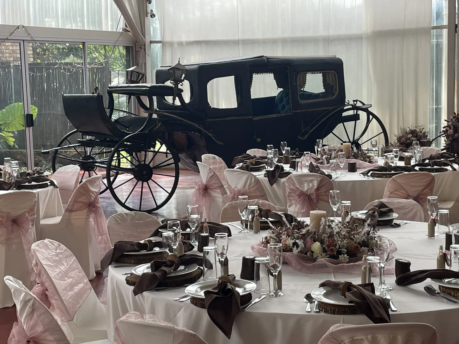 The antique horse-drawn carriage standing in Hilgard Hall, dressed for a wedding reception