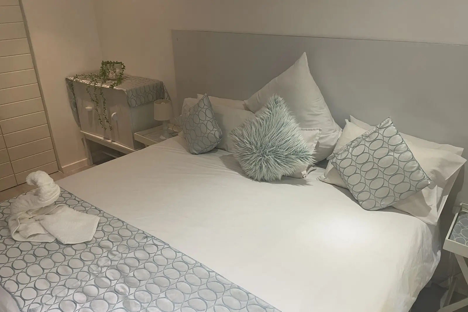 A room made up as a king bed with an en-suite bath