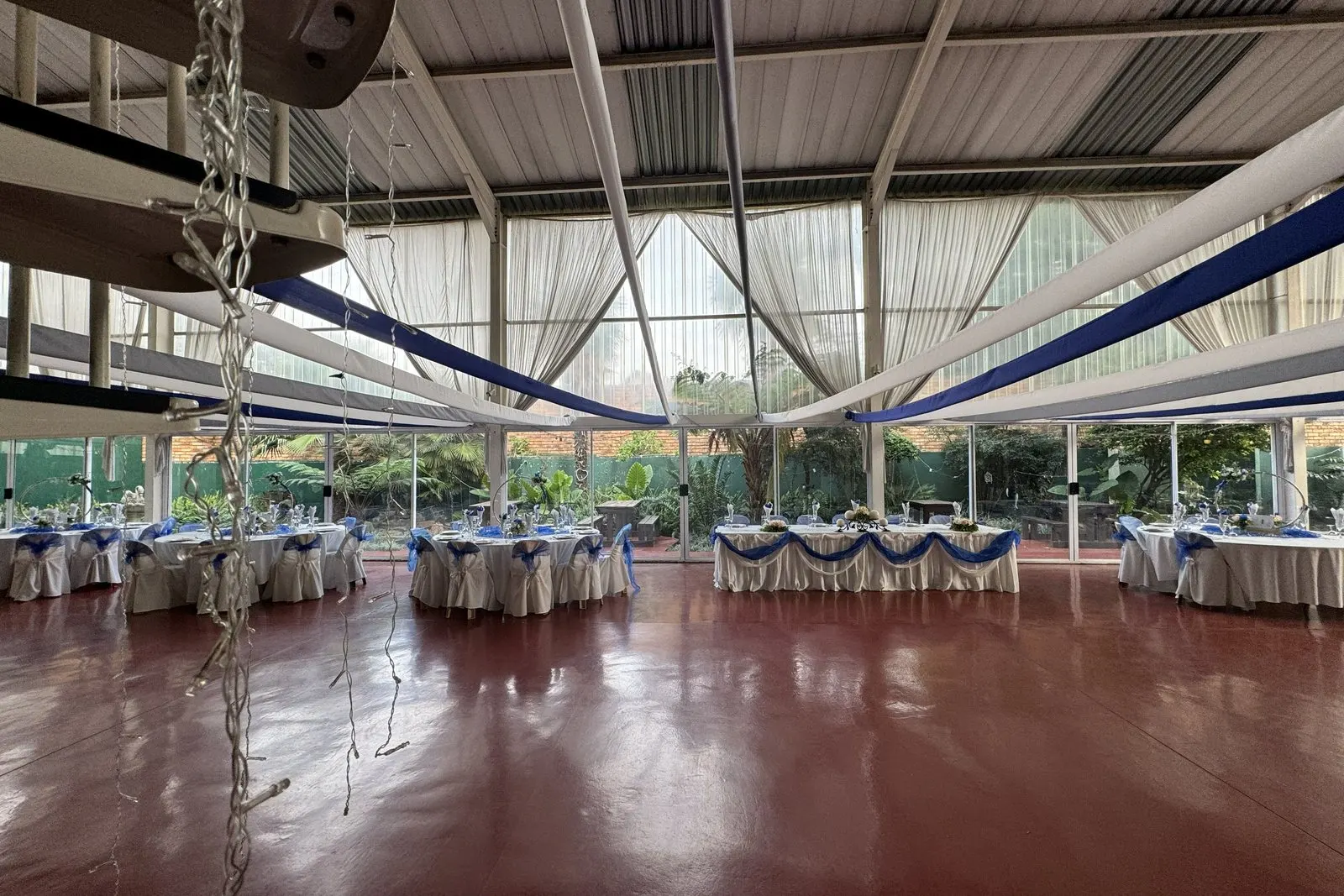 Hilgard Hall set up with round tables under soft evening lighting